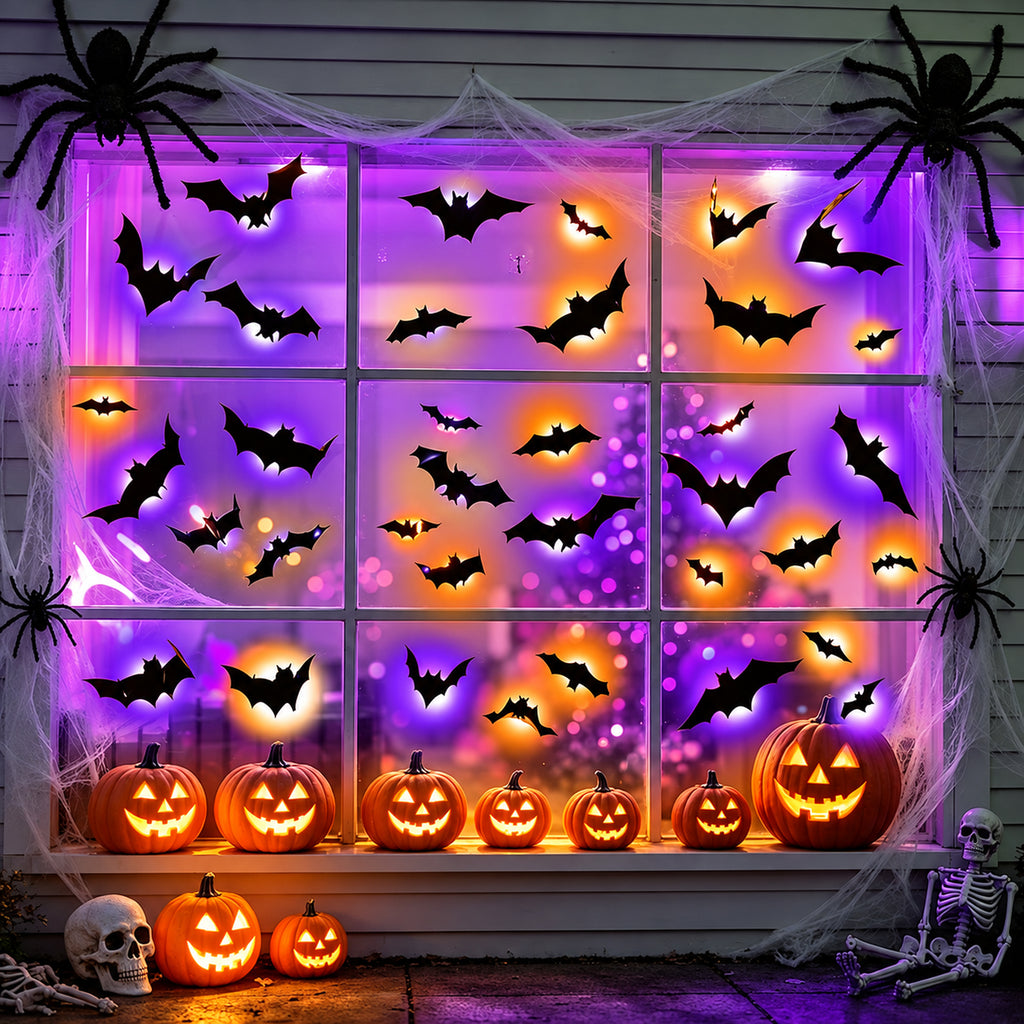 Window decorated with glowing bats and jack-o-lanterns