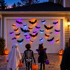 Trick-or-treaters in front of a garage decorated with glowing bats