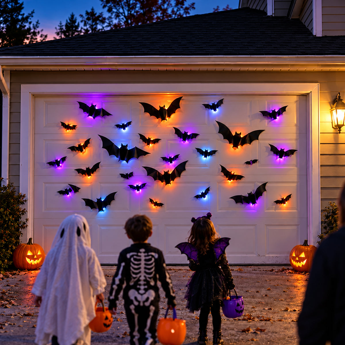 Trick-or-treaters in front of a garage decorated with glowing bats